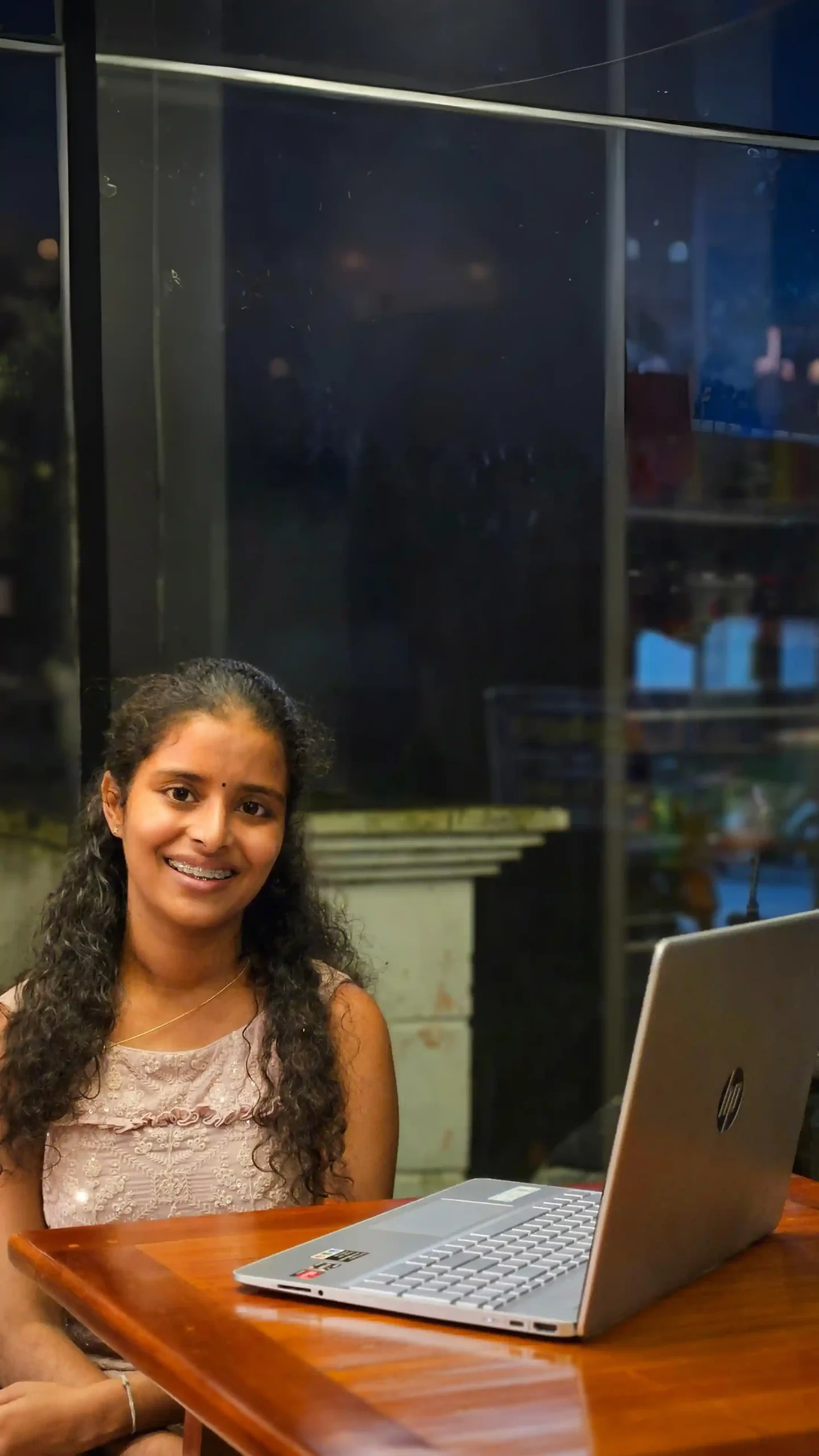 suyan sitting on a table infront of laptop seo expert in kerala